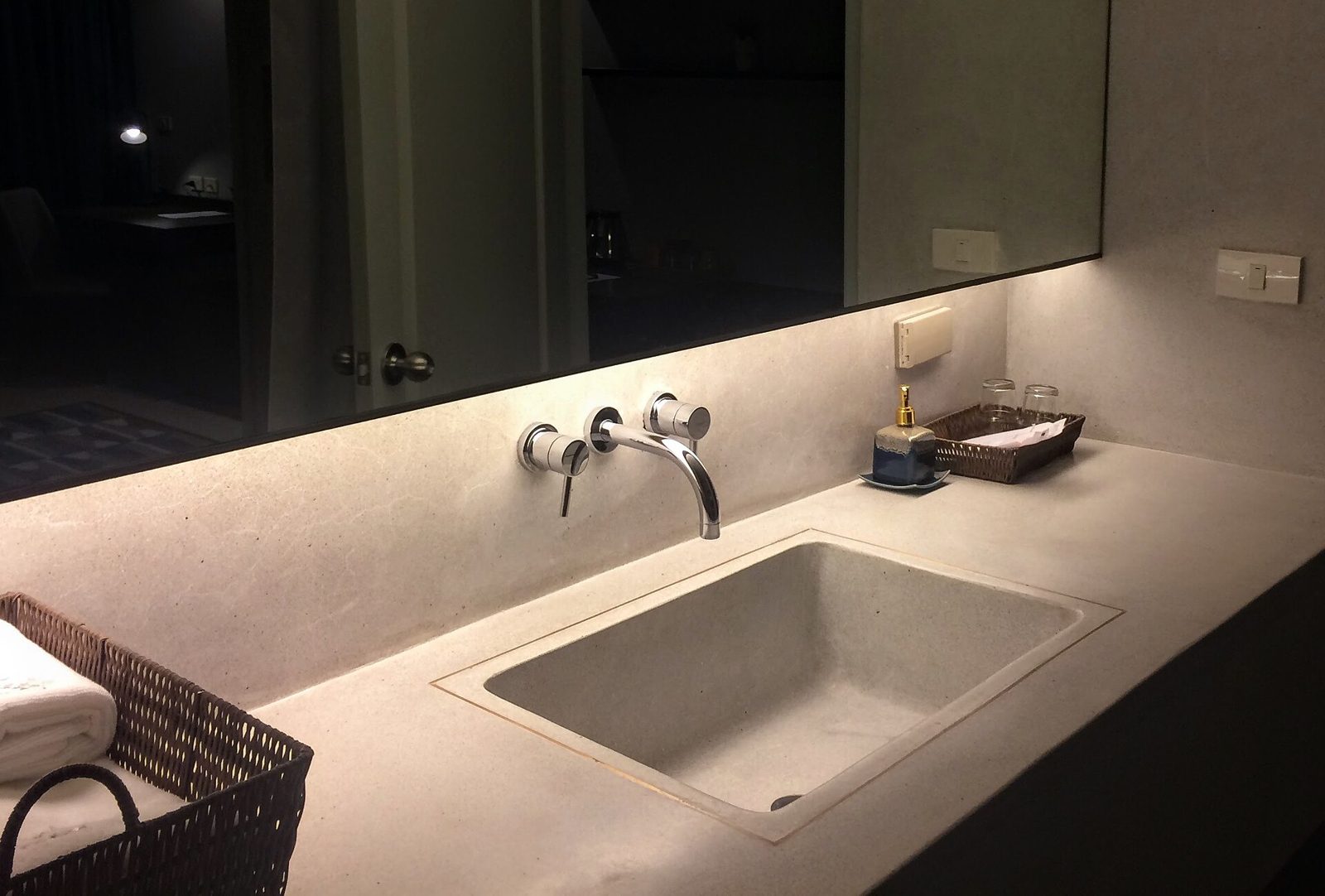 Illuminated stone vanity with wall-mounted faucet (stock inspiration photo)