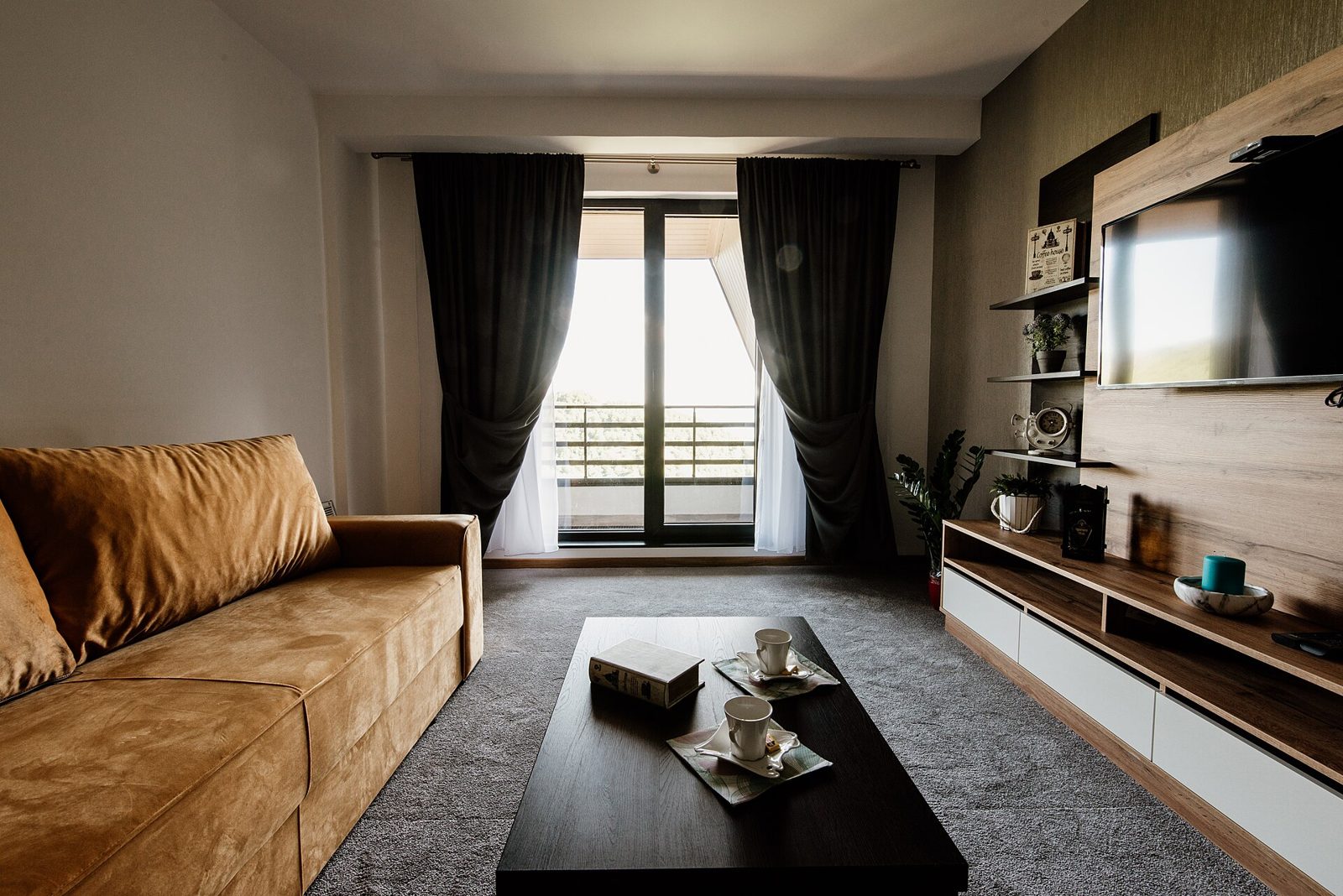 Living room with dark accent walls and drapery (stock inspiration photo)